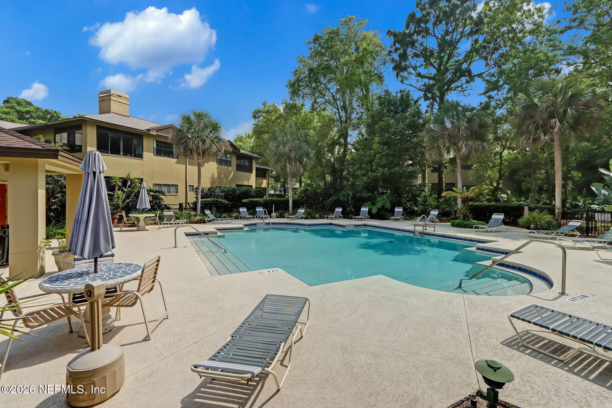10150 Belle Rive Boulevard, Unit 1109 Jacksonville, FL 32256 - Photo 48 of 55 a view of a patio with a table and chairs