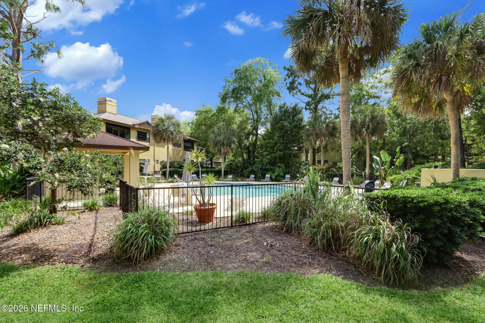 10150 Belle Rive Boulevard, Unit 1109 Jacksonville, FL 32256 - Photo 49 of 55 a view of a house with a yard and a tree