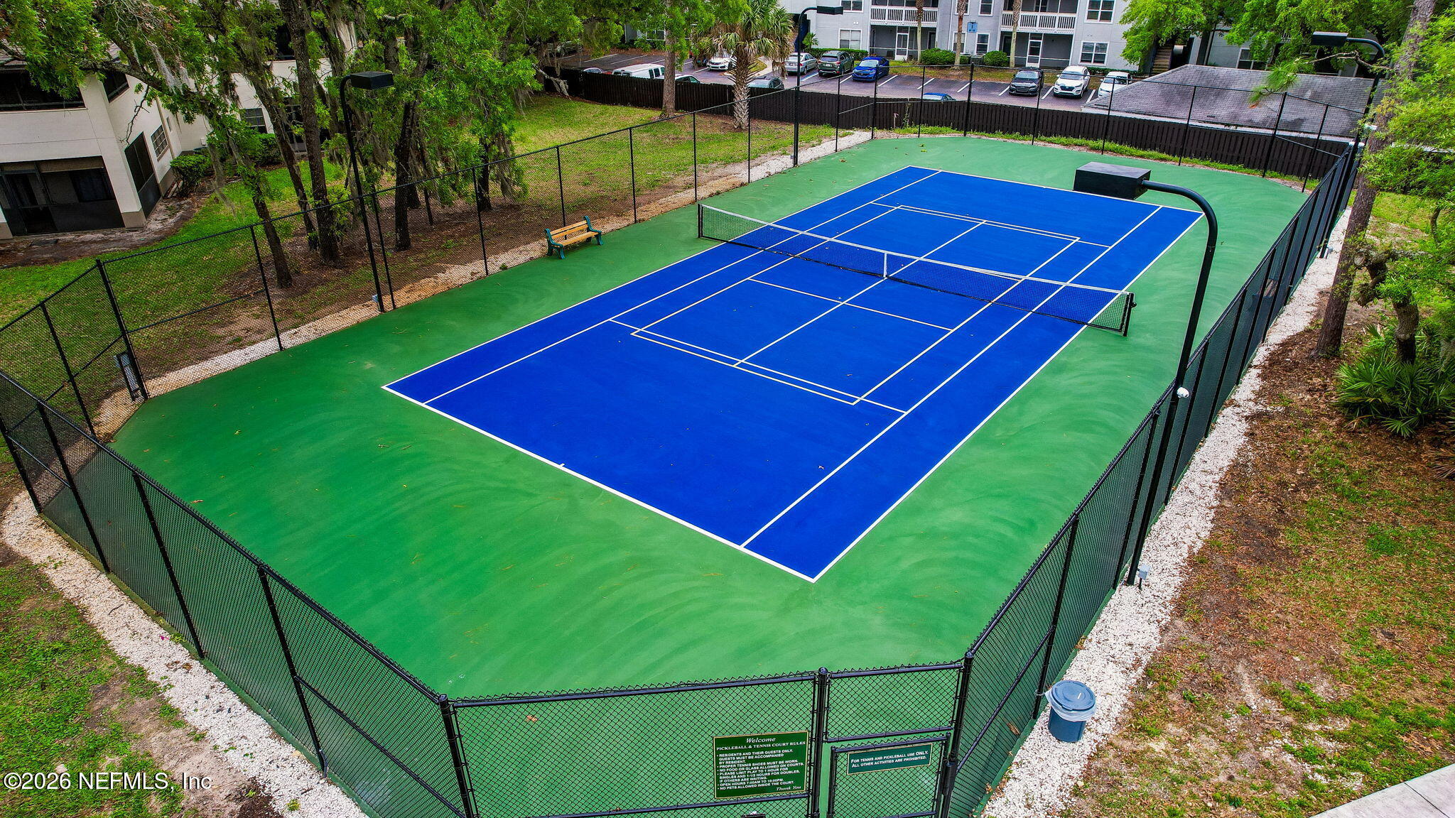 10150 Belle Rive Boulevard, Unit 1109 Jacksonville, FL 32256 - Photo 51 of 55 a view of a tennis ground with a small pool