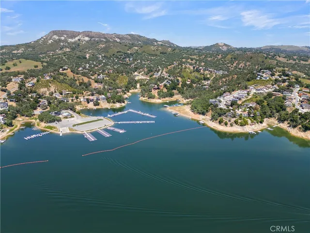 an aerial view of lake residential house with outdoor space and trees around