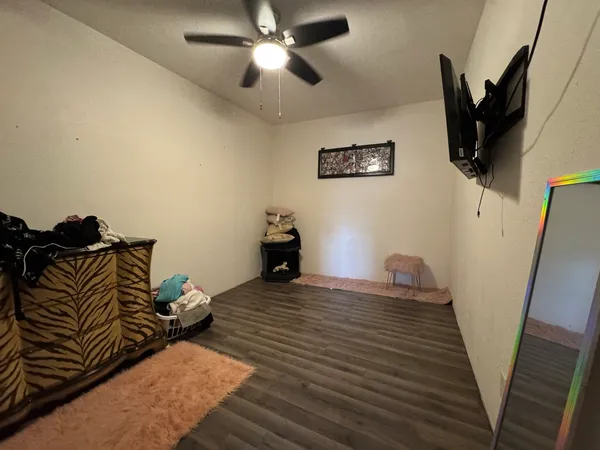 a bedroom with a bed and wooden floor