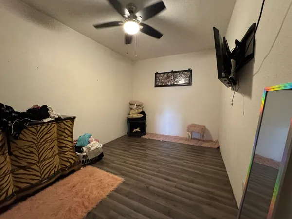 a bedroom with bed and wooden floor