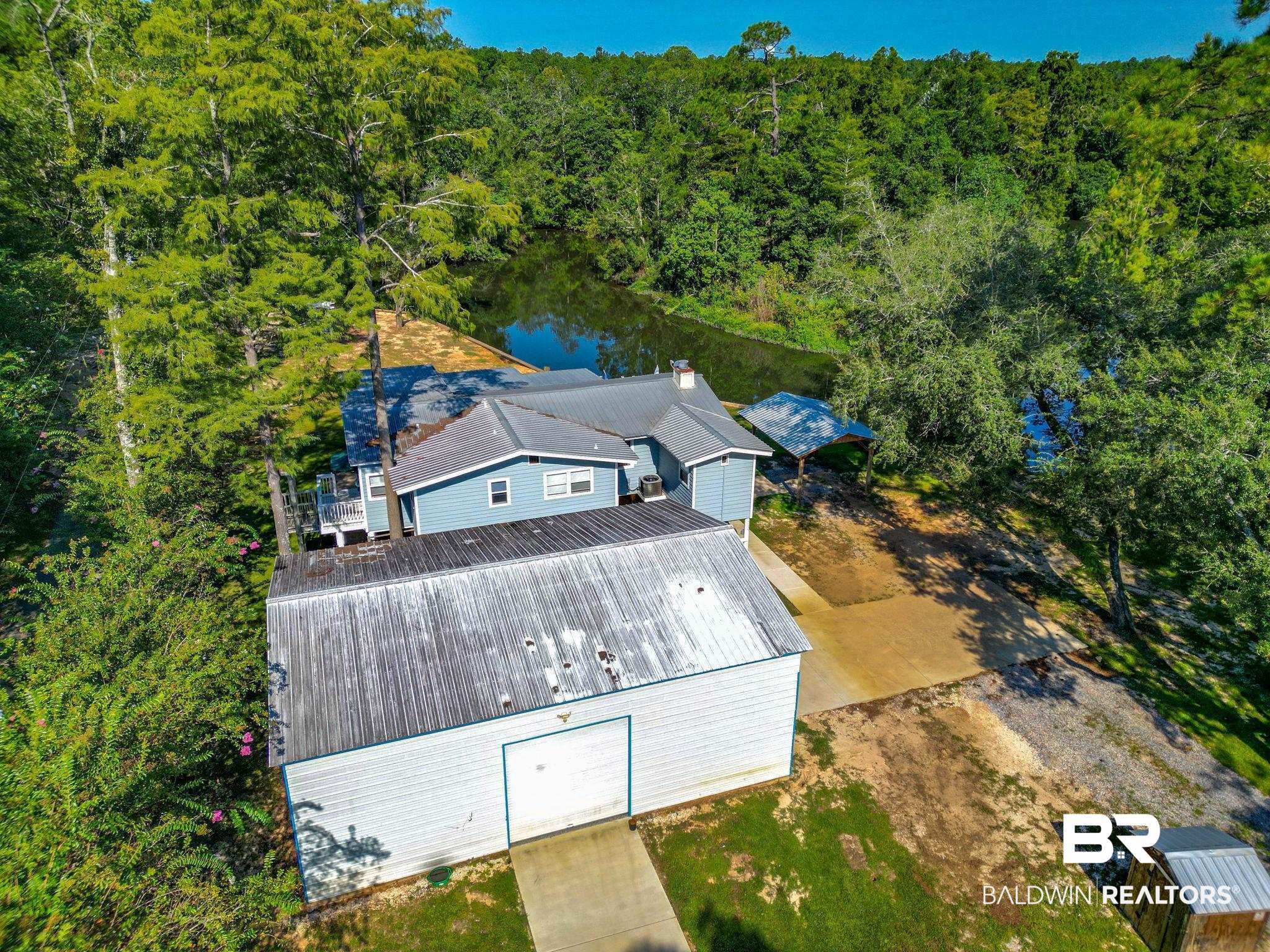 12855 Woodhaven Dairy Road West Silverhill, AL 36576 - Photo 25 of 27 View of subject property with a heavily wooded area and a large body of water
