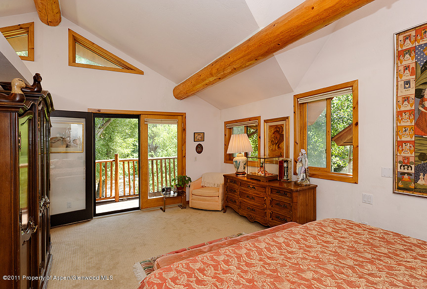 642 Frying Pan Road Basalt, CO 81621 - Photo 6 of 20 a bedroom with furniture and large windows