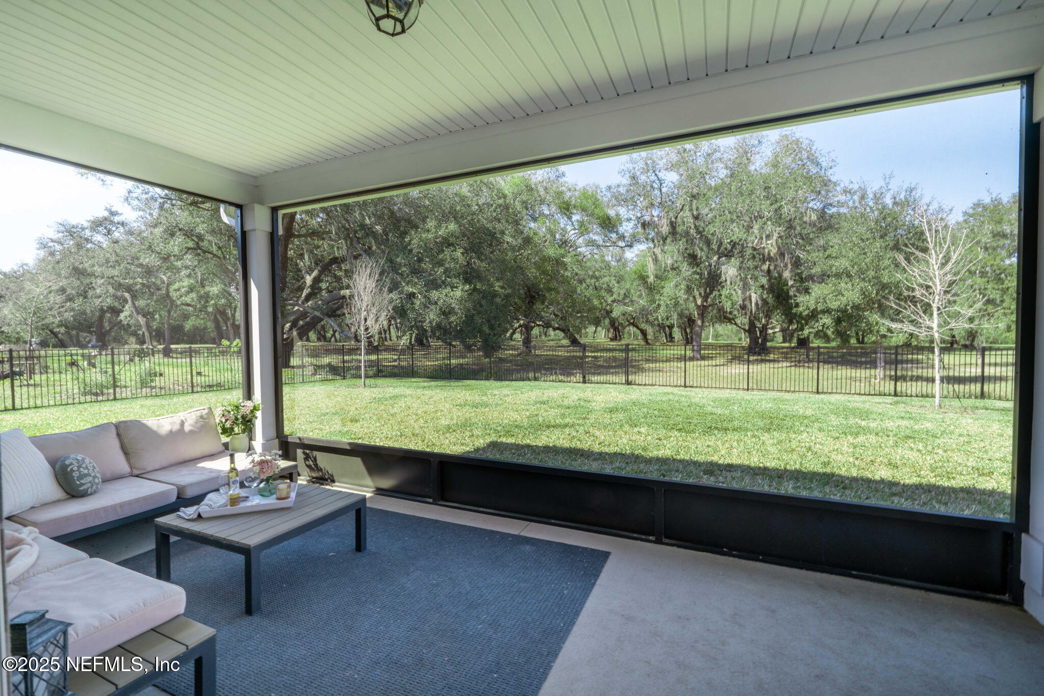 61 Oak Cluster Lane St. Augustine, FL 32092 - Photo 28 of 45 a living room with patio furniture and a garden