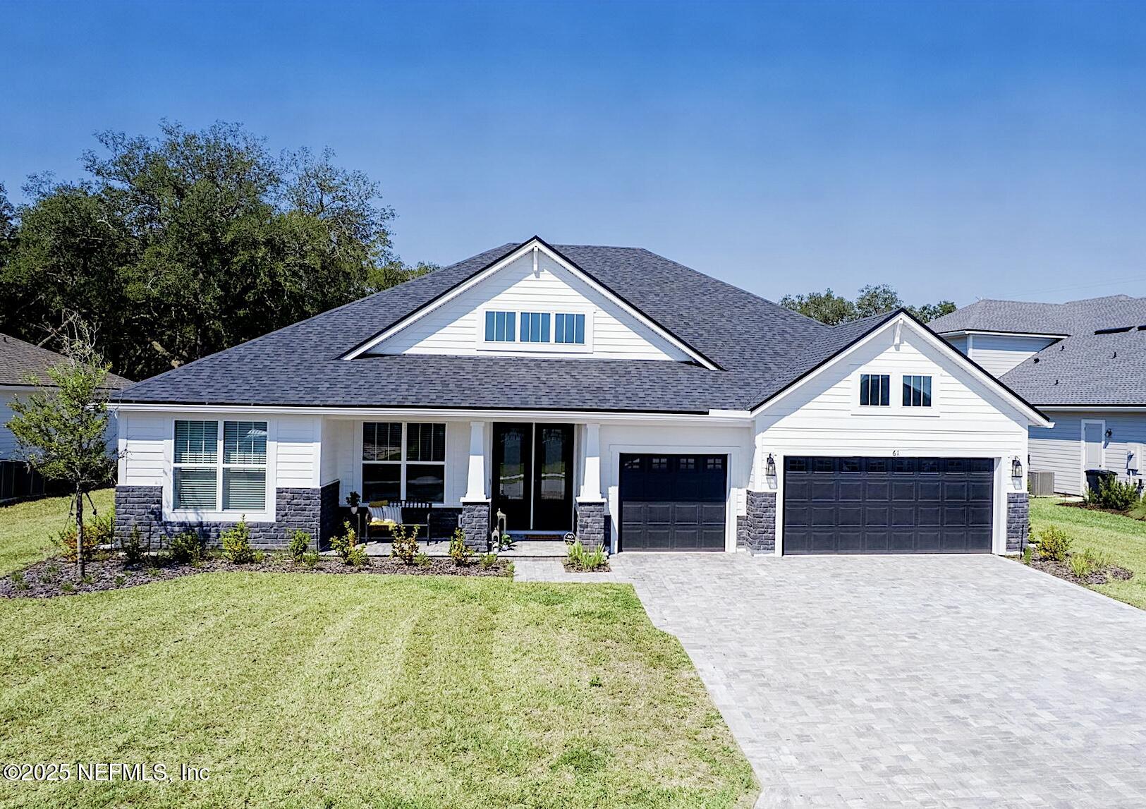 61 Oak Cluster Lane St. Augustine, FL 32092 - Photo 34 of 45 a front view of a house with a yard and garage