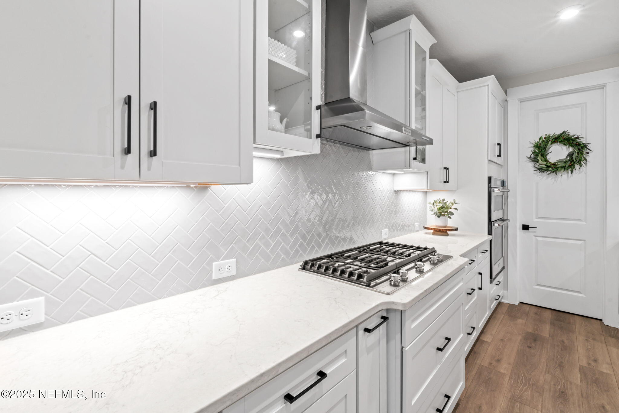 61 Oak Cluster Lane St. Augustine, FL 32092 - Photo 10 of 45 a kitchen with white cabinets and appliances