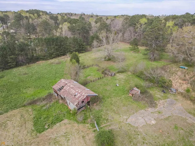 a view of a wooden house with a yard