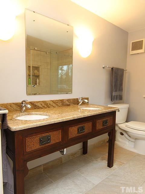 1605 Westhaven Drive Raleigh, NC 27607 - Photo 16 of 23 a bathroom with a granite countertop sink a toilet and mirror