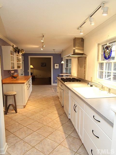 1605 Westhaven Drive Raleigh, NC 27607 - Photo 7 of 23 a large kitchen with stainless steel appliances a stove a sink dishwasher and cabinets