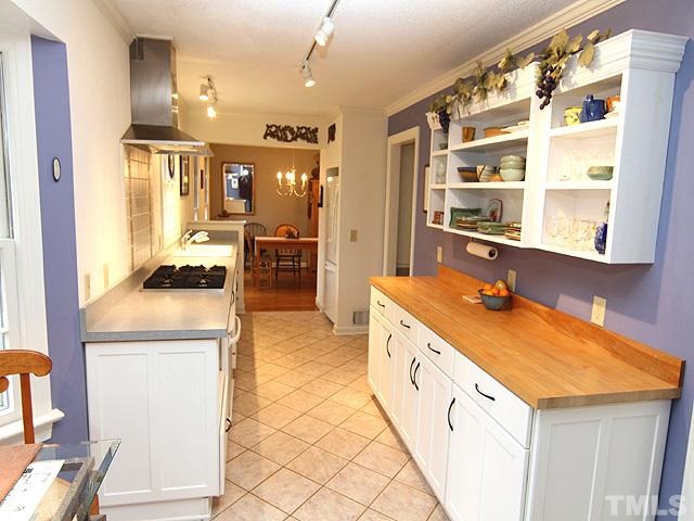 1605 Westhaven Drive Raleigh, NC 27607 - Photo 9 of 23 a large kitchen with granite countertop a sink and a refrigerator