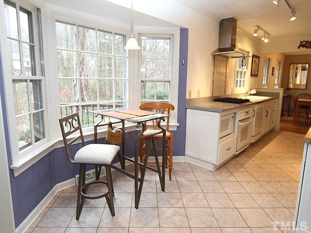 1605 Westhaven Drive Raleigh, NC 27607 - Photo 10 of 23 a kitchen with stainless steel appliances a table and chairs in it