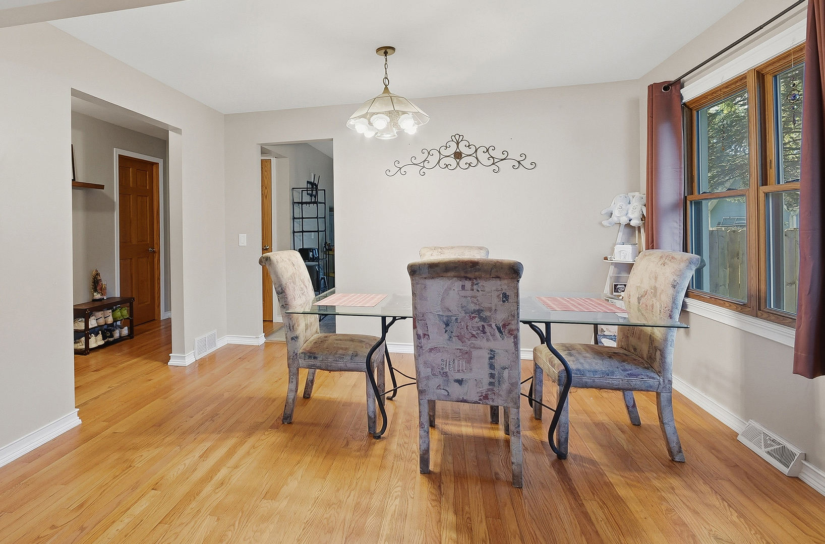 5155 West Main Street Monee, IL 60449 - Photo 9 of 19 a dining room with wooden floor a chandelier a glass table and chairs