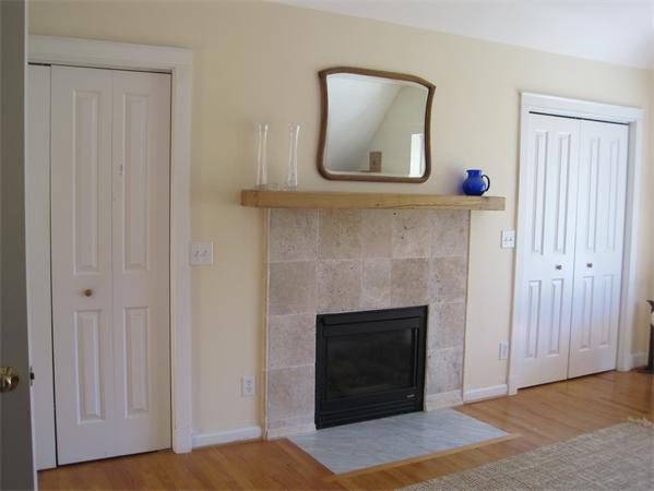 76 Taylor Road Stow, MA 01775 - Photo 13 of 27 a living room with a fireplace and a wooden floor