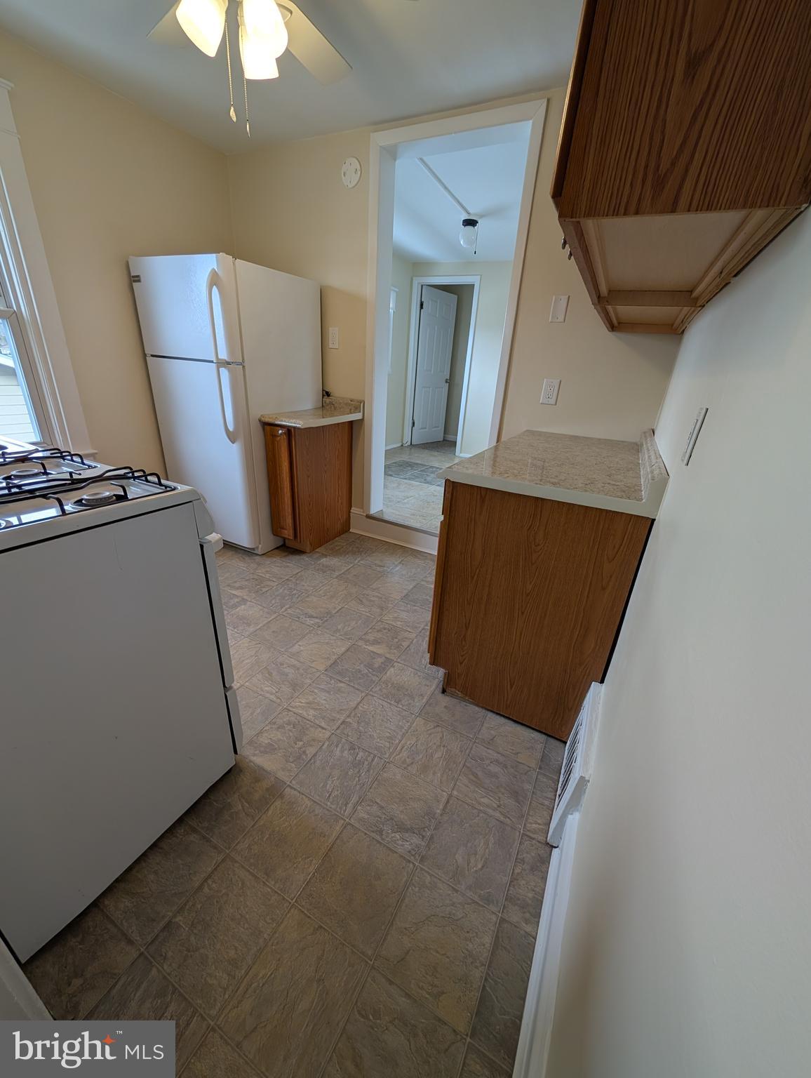 30 West Roland Road Brookhaven, PA 19015 - Photo 3 of 17 a living room with couches and kitchen view with wooden floor
