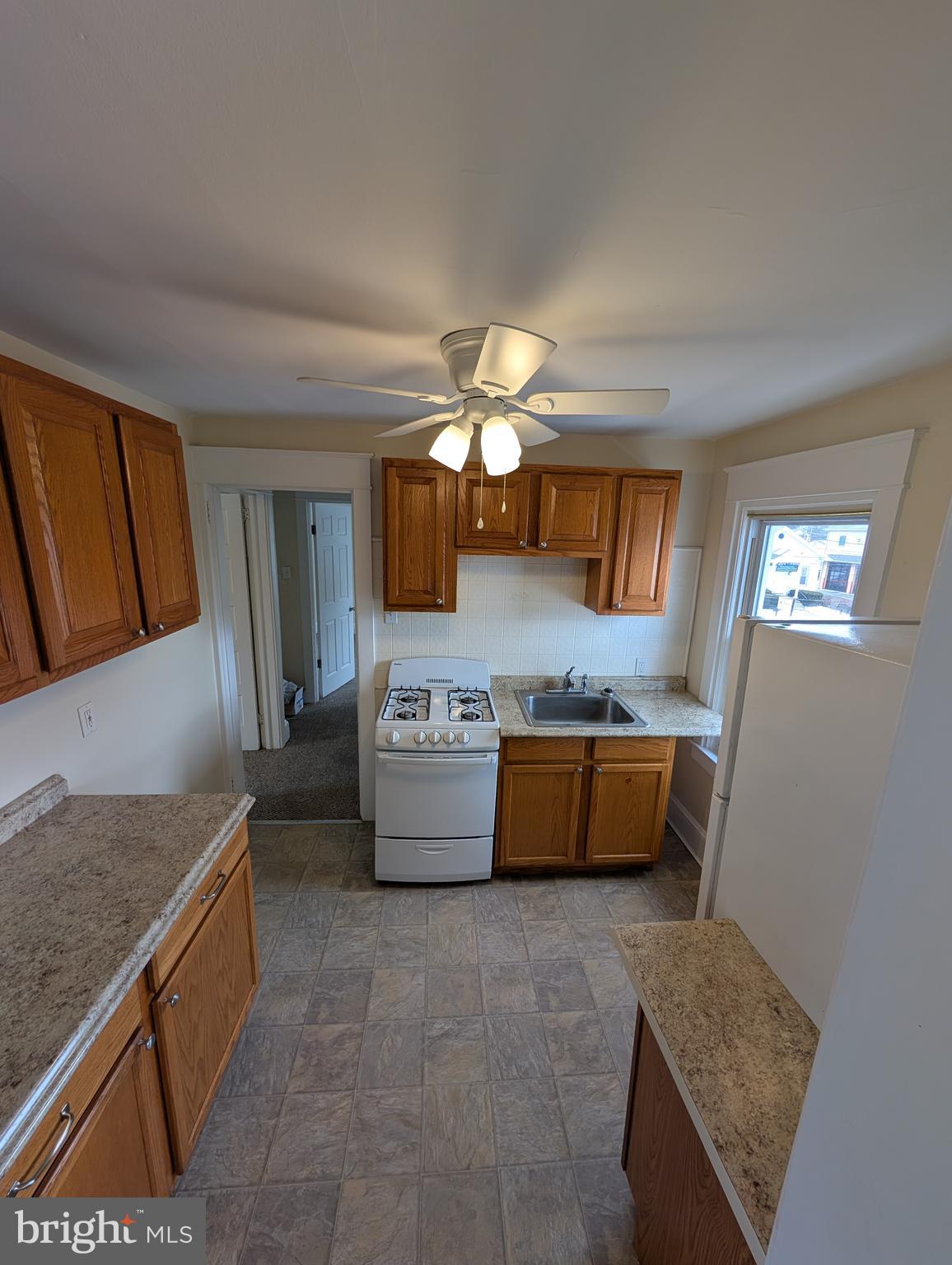 30 West Roland Road Brookhaven, PA 19015 - Photo 4 of 17 a kitchen with granite countertop a stove and cabinets
