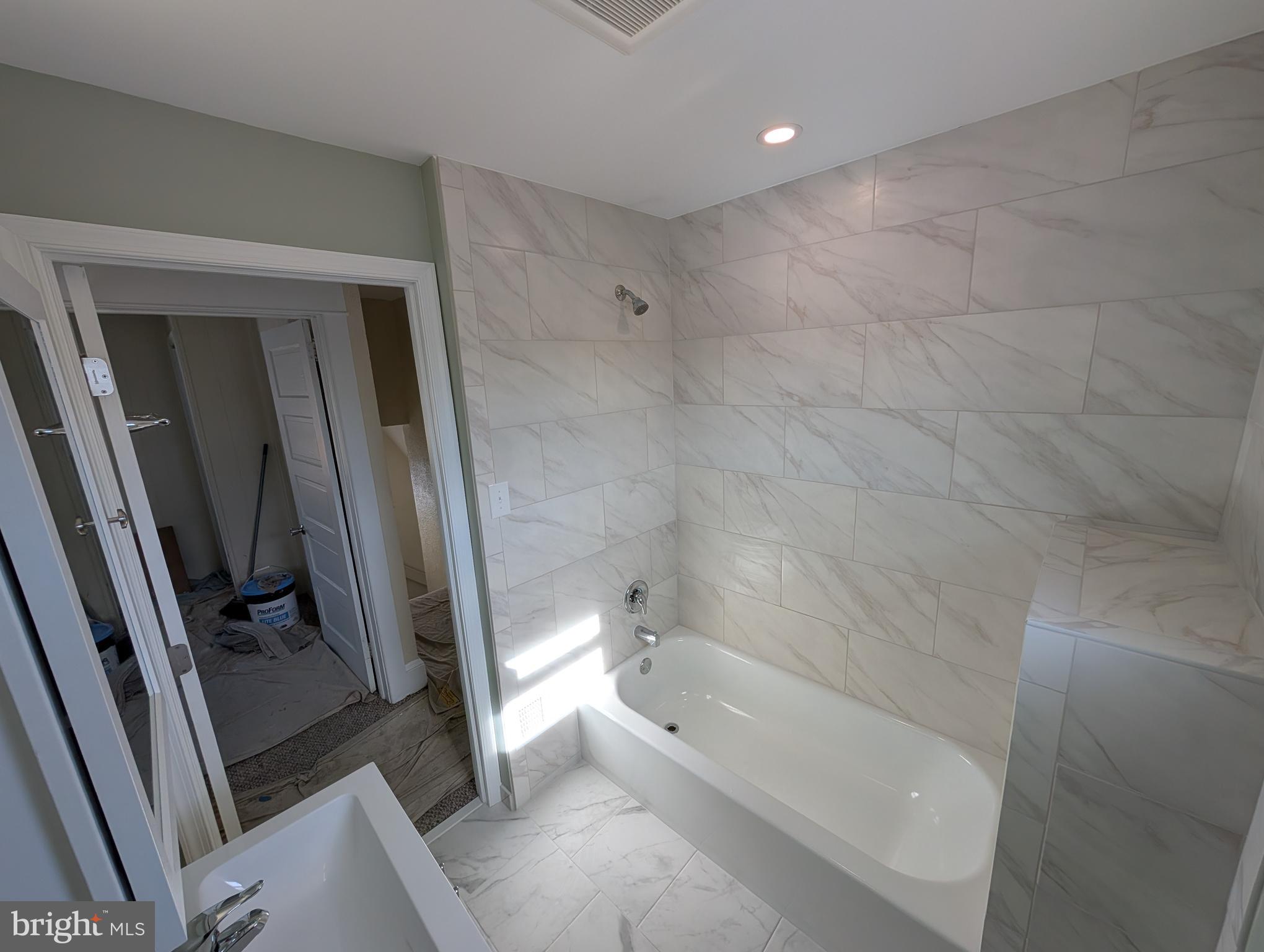 30 West Roland Road Brookhaven, PA 19015 - Photo 7 of 17 a bathroom with a bathtub and a shower