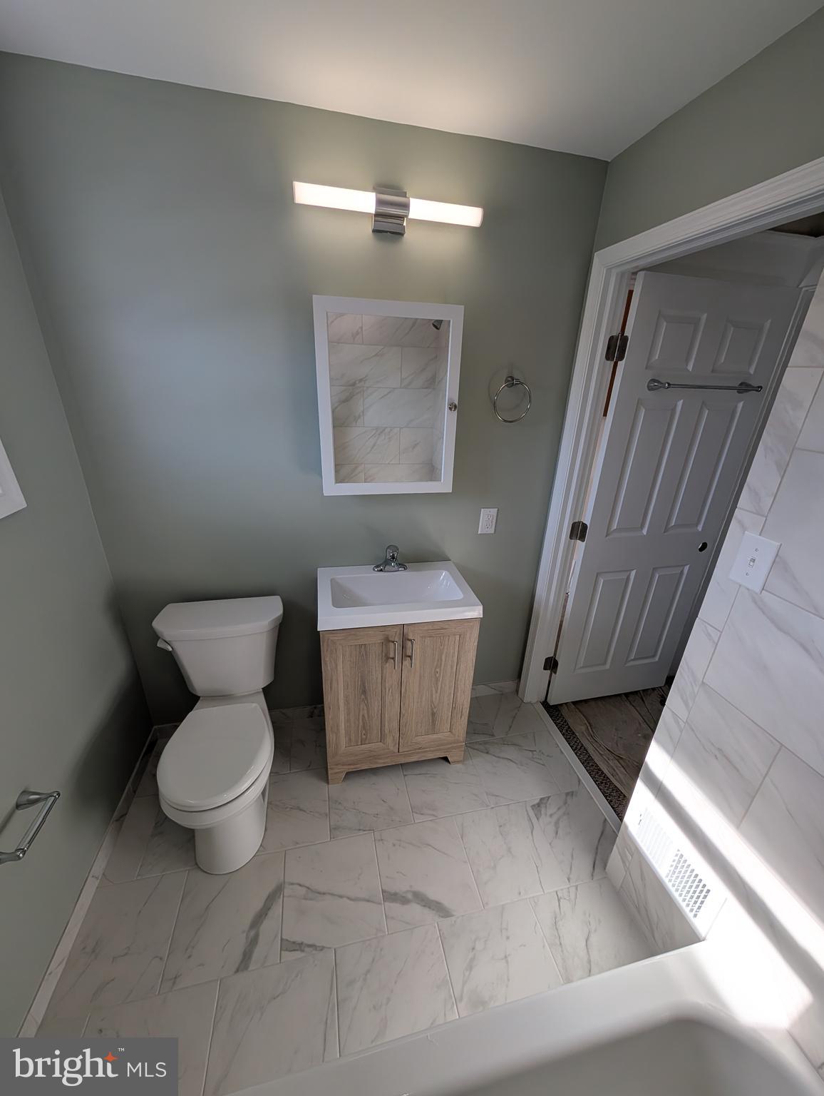 30 West Roland Road Brookhaven, PA 19015 - Photo 8 of 17 a bathroom with a toilet and a sink