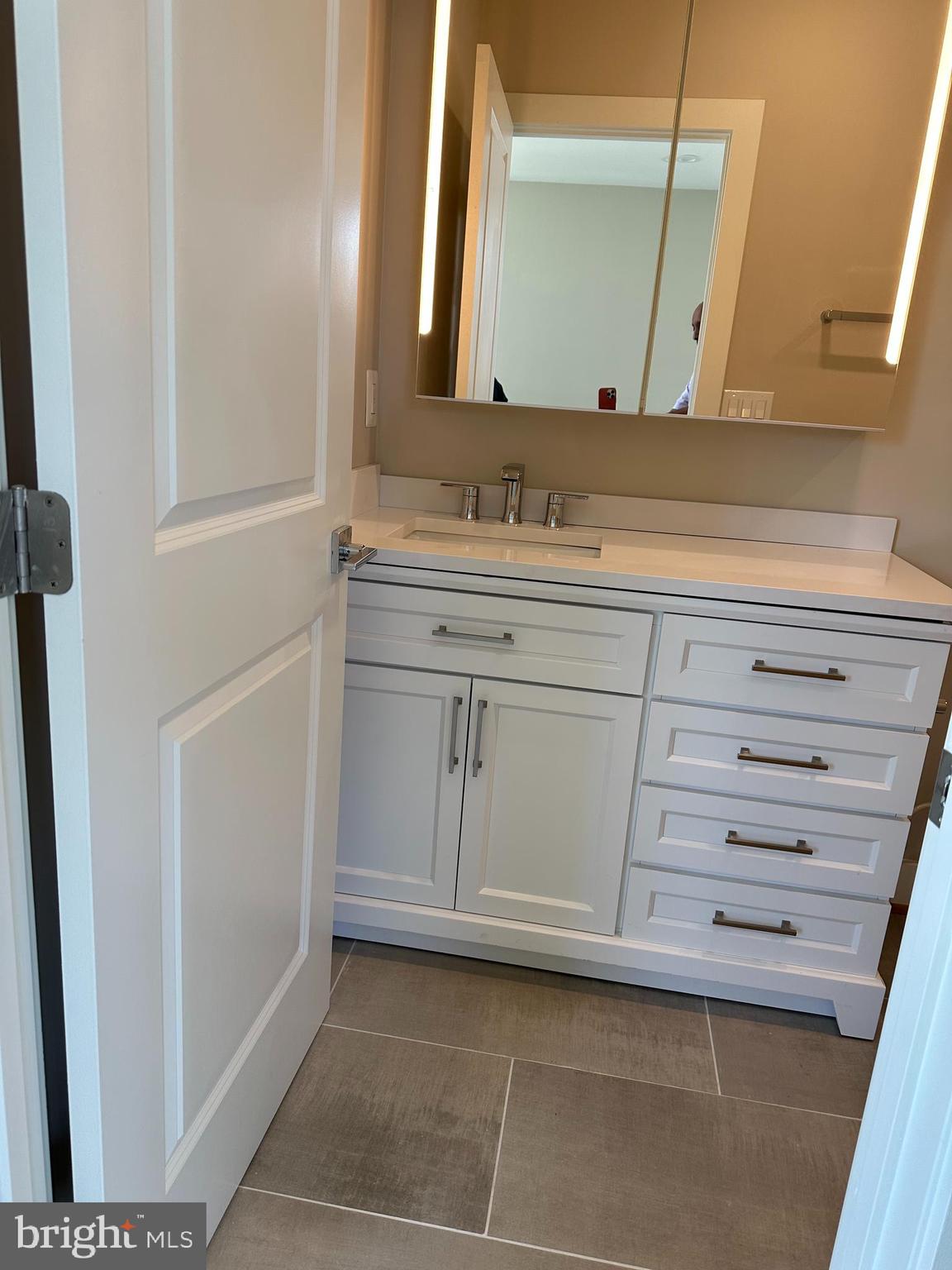 234 15th Street Northeast Washington, DC 20002 - Photo 11 of 15 a bathroom with a sink and a mirror