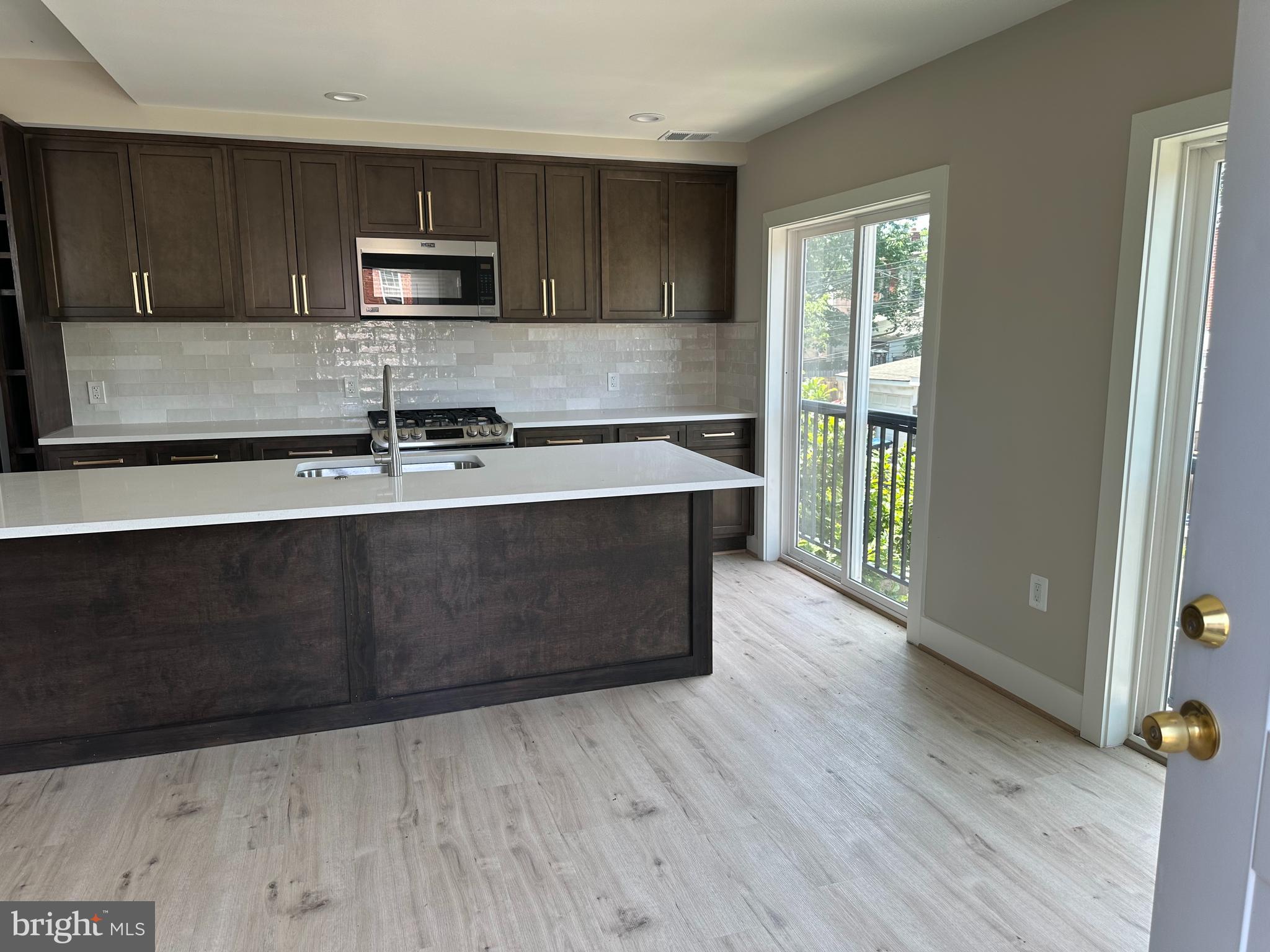 234 15th Street Northeast Washington, DC 20002 - Photo 2 of 15 a kitchen with wooden floors and wooden cabinets