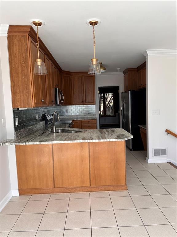 403 Landon Gate Pittsburgh, PA 15215 - Photo 14 of 27 a view of a kitchen with kitchen island granite countertop a refrigerator a sink and dishwasher