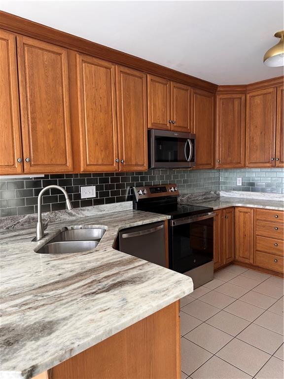 403 Landon Gate Pittsburgh, PA 15215 - Photo 16 of 27 a kitchen with granite countertop a stove top oven microwave and cabinets