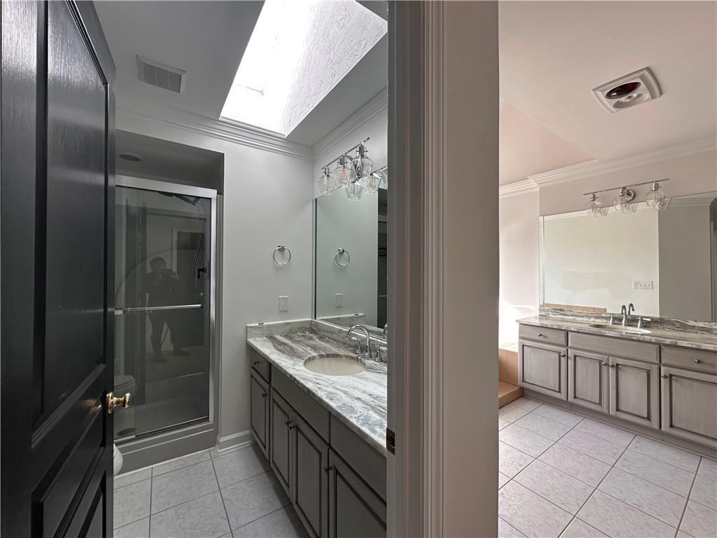 403 Landon Gate Pittsburgh, PA 15215 - Photo 25 of 27 a bathroom with a granite countertop sink a mirror and a bathtub