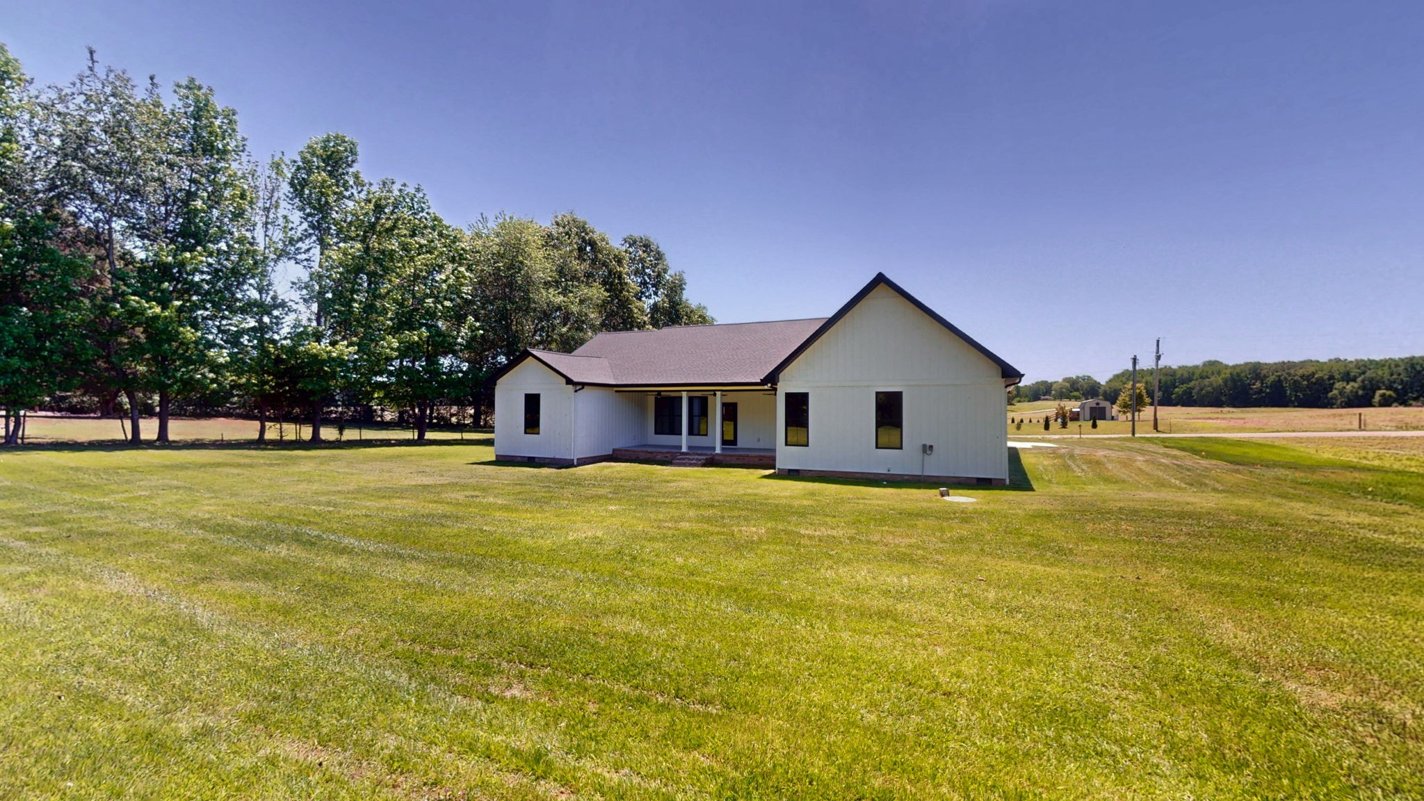 865 Alman Cemetery Road Paris, TN 38242 - Photo 36 of 41 a front view of house with yard and trees in the background
