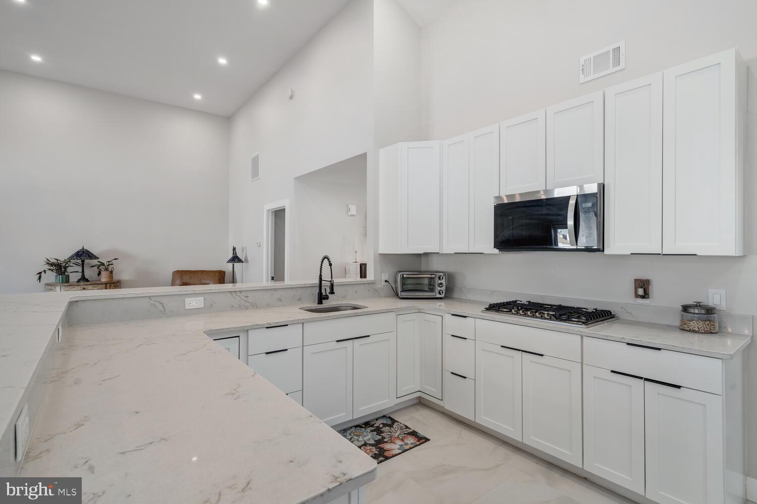 148 Compass Road Manahawkin, NJ 08050 - Photo 20 of 40 a kitchen with appliances a sink and cabinets