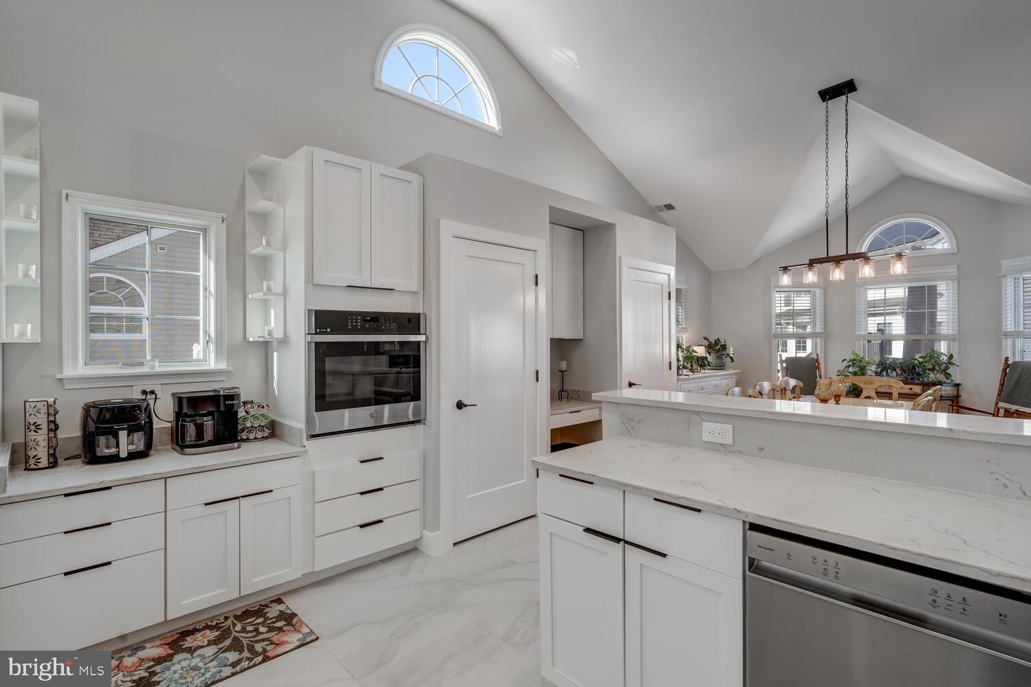 148 Compass Road Manahawkin, NJ 08050 - Photo 21 of 40 a kitchen with stainless steel appliances kitchen island granite countertop a sink a stove and cabinets