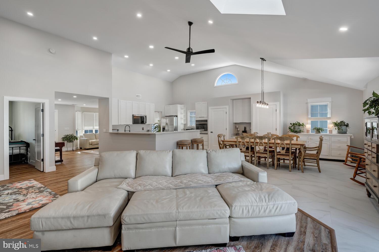 148 Compass Road Manahawkin, NJ 08050 - Photo 28 of 40 a living room with furniture kitchen view and a chandelier