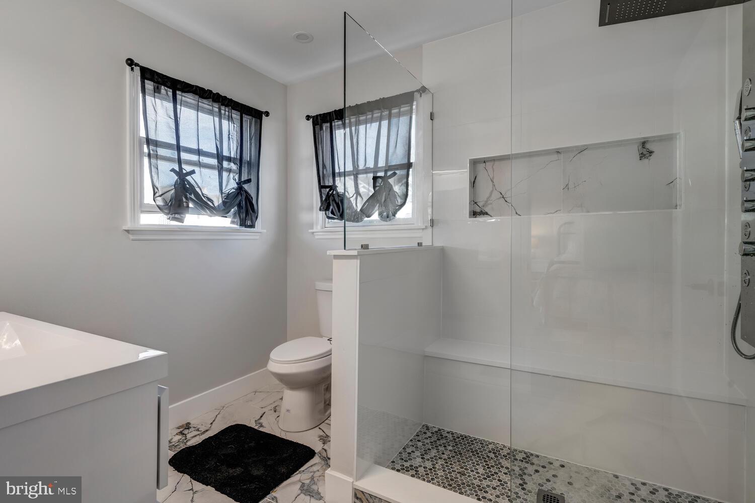 148 Compass Road Manahawkin, NJ 08050 - Photo 37 of 40 a bathroom with a toilet a sink a window and shower