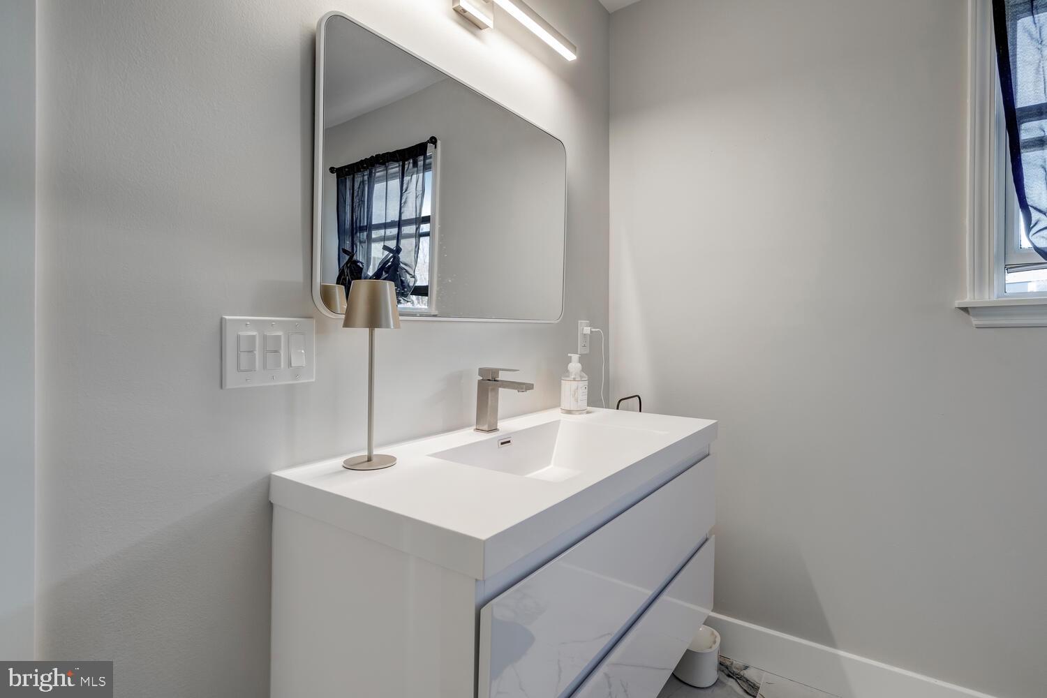 148 Compass Road Manahawkin, NJ 08050 - Photo 38 of 40 a bathroom with a sink and a mirror