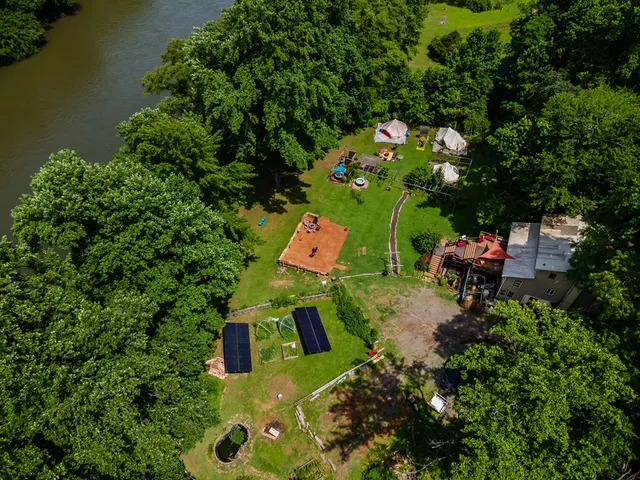 an aerial view of a house with a yard