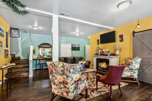a bedroom with a bed a flat screen tv and dresser