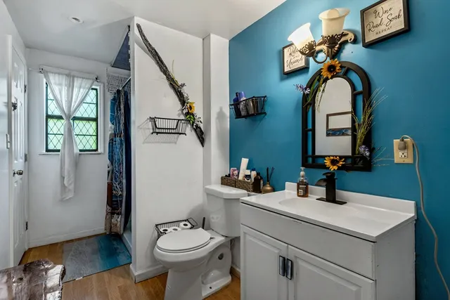 a bed sitting in a bedroom next to a window