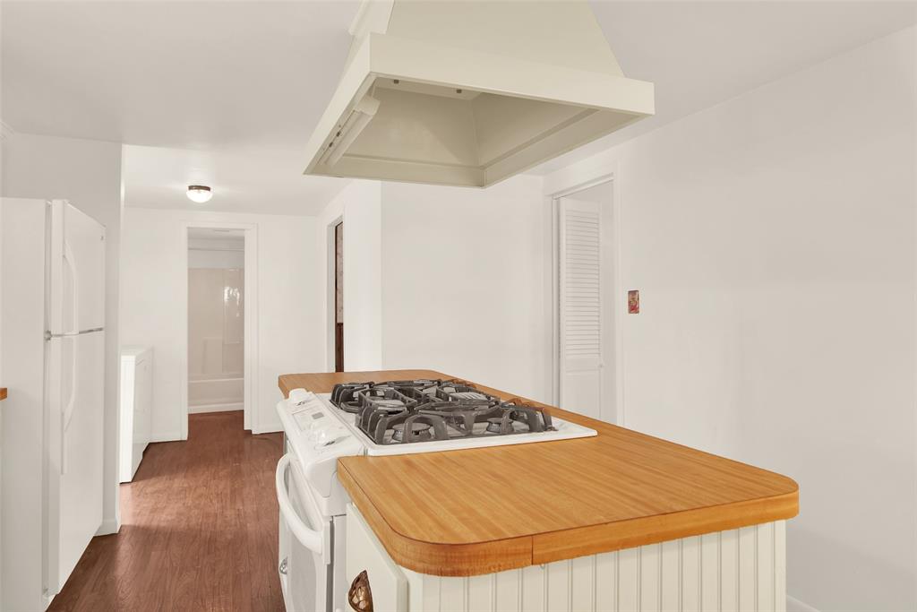 404 North Blanton Whitewright, TX 75491 - Photo 14 of 34 a bedroom with a bed and a wooden floor