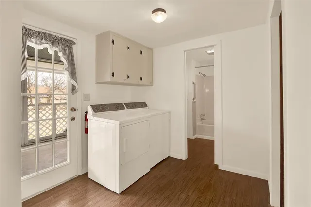 a view of utility room with closet and wooden floor