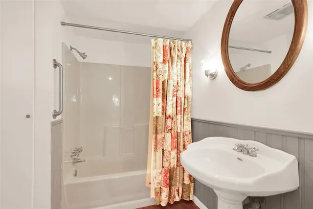 a bathroom with a sink a mirror and a bathtub