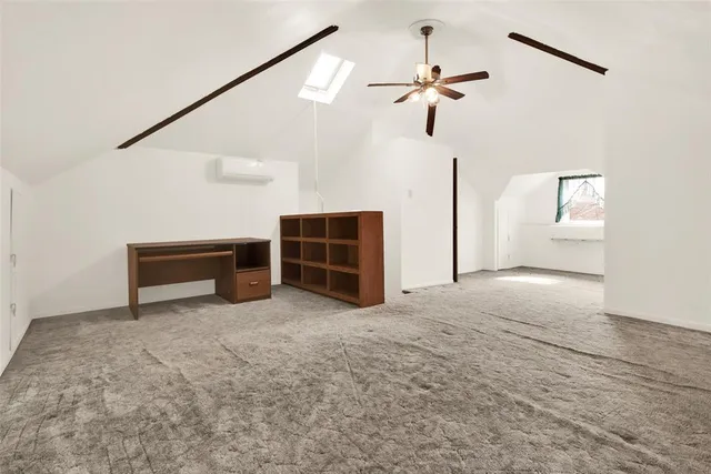 a view of an empty room with a ceiling fan