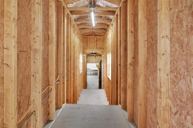a view of a hallway with wooden door