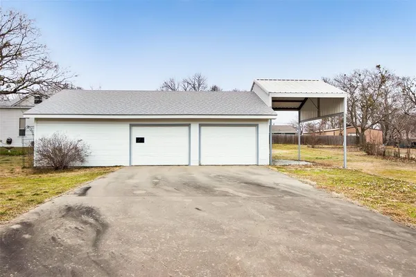 a view of a house with a yard and garage