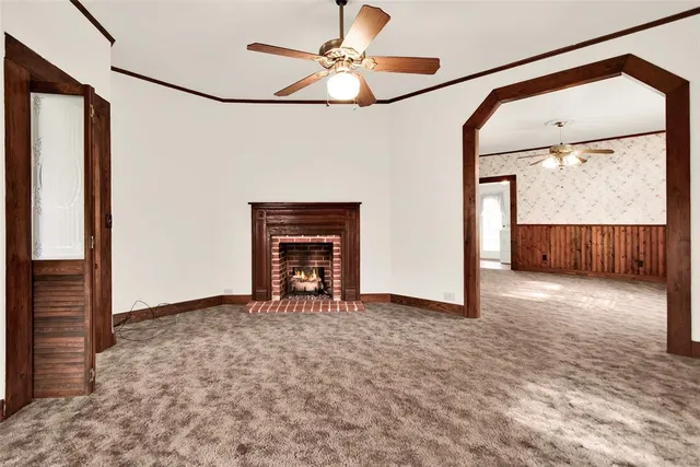 a view of an empty room with a fireplace