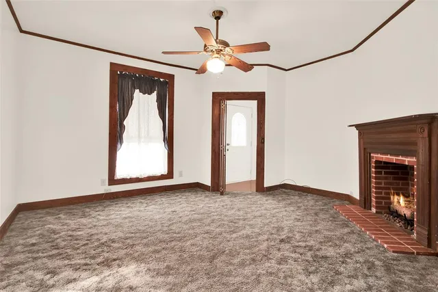 a view of an empty room with a fireplace