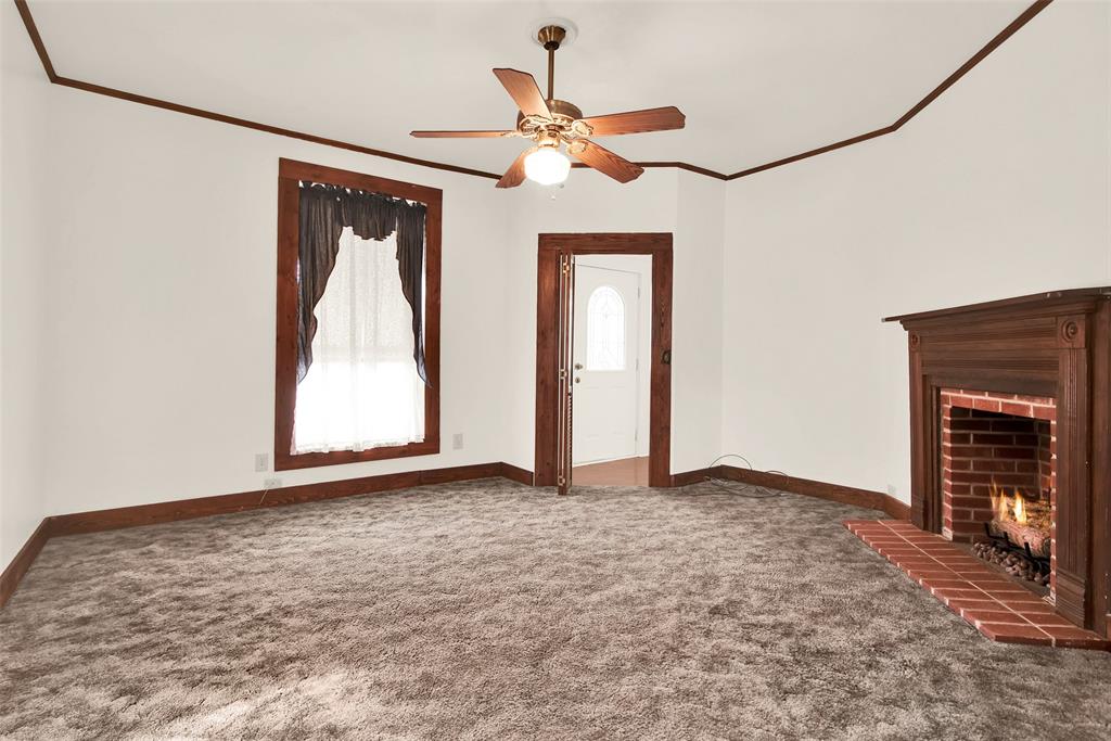 404 North Blanton Whitewright, TX 75491 - Photo 8 of 34 a view of an empty room with a fireplace