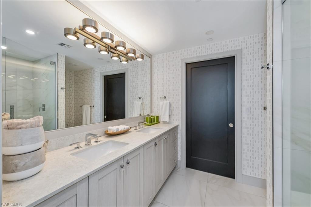 13925 Old Coast Road, Unit 403 Naples, FL 34110 - Photo 14 of 24 Full bath with double vanity and a stall shower