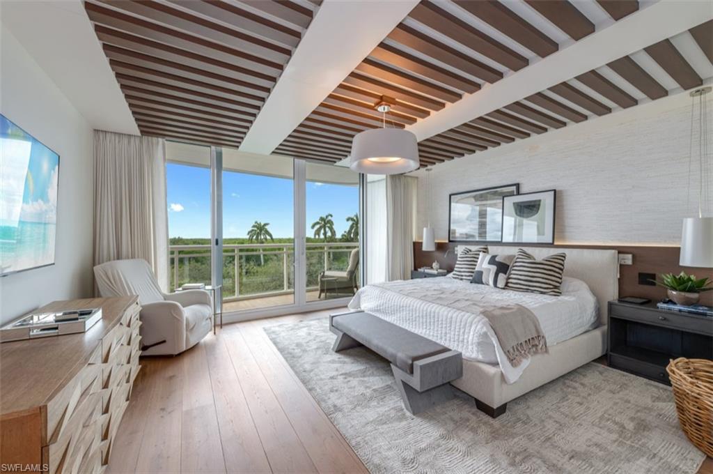 13925 Old Coast Road, Unit 403 Naples, FL 34110 - Photo 20 of 24 Bedroom with a wall of windows, hardwood / wood-style floors, and beamed ceiling