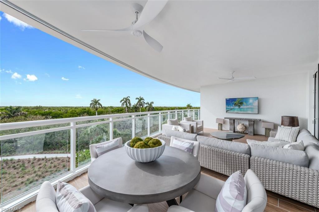 13925 Old Coast Road, Unit 403 Naples, FL 34110 - Photo 2 of 24 Balcony with ceiling fan, outdoor lounge area, and outdoor dining area