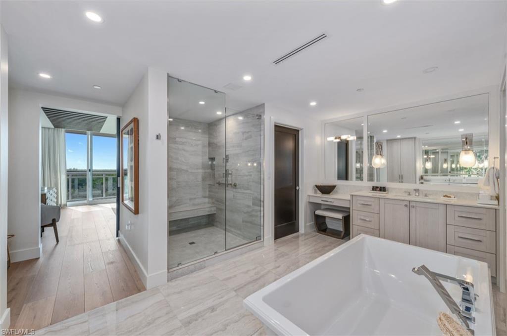 13925 Old Coast Road, Unit 403 Naples, FL 34110 - Photo 23 of 24 Bathroom with vanity, a soaking tub, a shower stall, light marble finish flooring, and recessed lighting