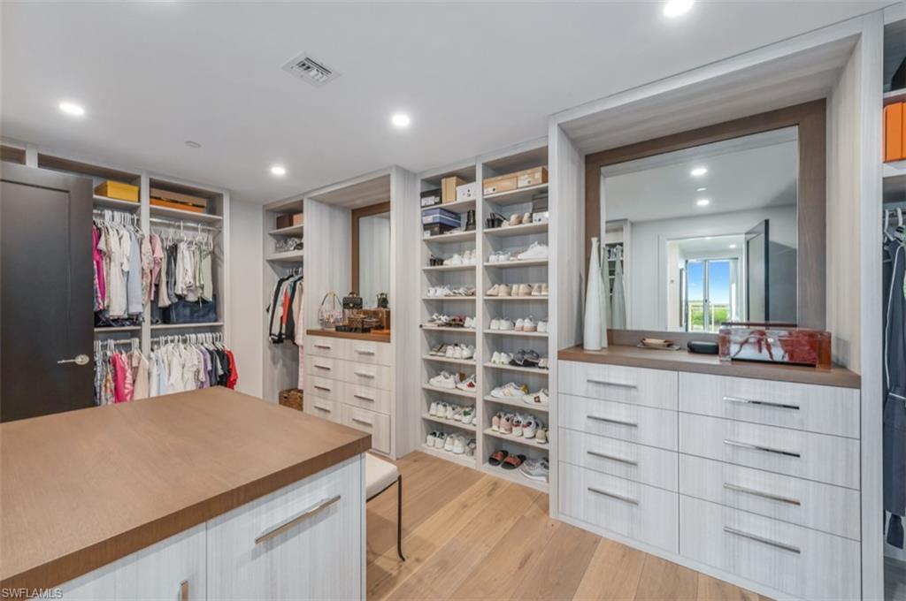 13925 Old Coast Road, Unit 403 Naples, FL 34110 - Photo 24 of 24 Walk in closet featuring light wood-style floors